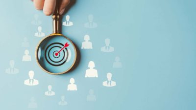 HRM or Human Resource Management, Magnifier glass focus to manager business icon which is among staff icons for human development recruitment leadership and customer target group concept.